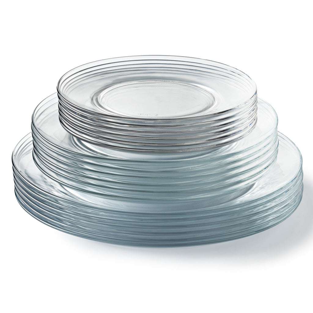 Stack of clear Duralex Lys glass dinnerware plates from the 18 piece set, showcasing a modern and elegant design.