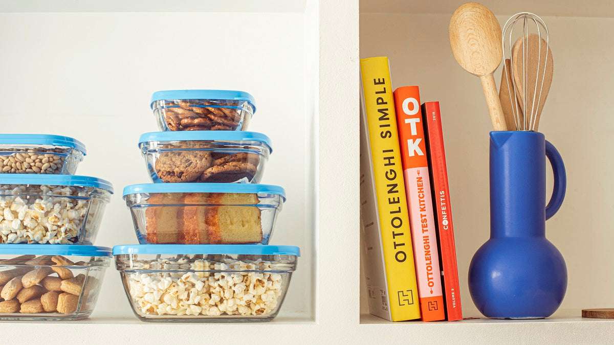 Duralex Freshbox Glass Square Bowls arranged on a kitchen shelf alongside cookbooks and utensils.