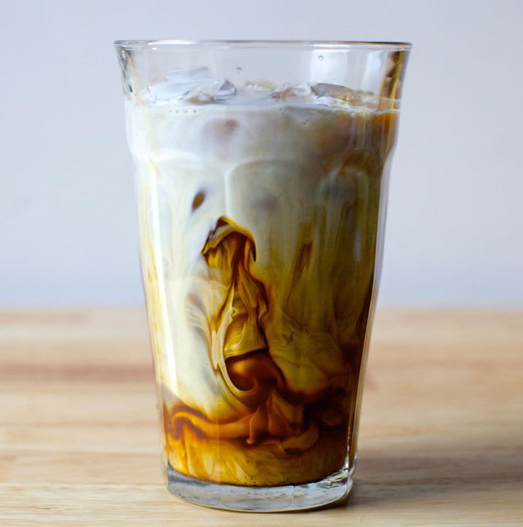 Le Picardie® Clear Glass Tumbler - Set of 6 by Duralex, featuring a glass filled with iced coffee, showcasing its versatility for cold drinks.