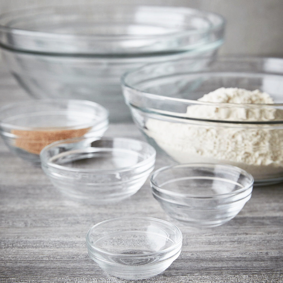 Le Gigogne® Stackable Clear Glass Bowls by Duralex displayed in various sizes, ideal for food prep, mixing, and serving.